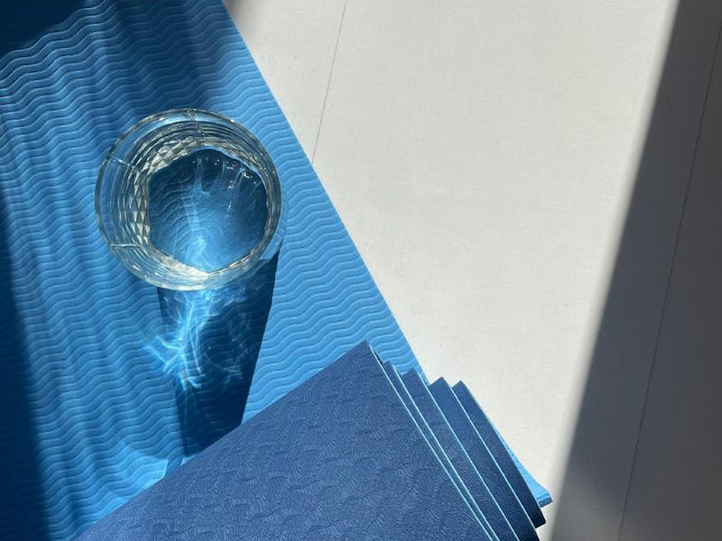 A clean, bright open space with a yoga mat on the floor, ready for practice.